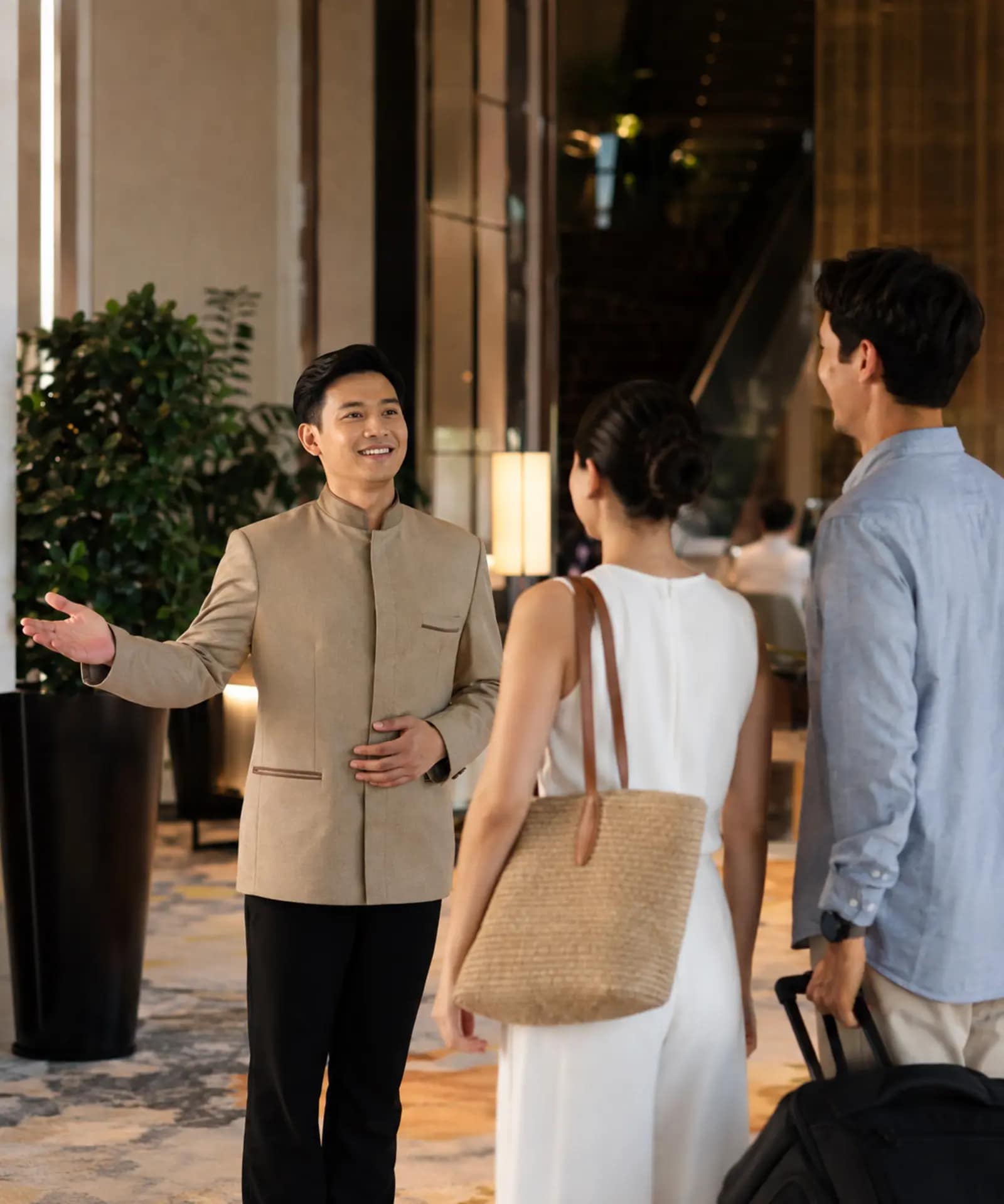 NH Bangkok Sukhumvit Boulevard Review: Is It Worth the Stay? 12 Hotel concierge welcoming travellers in a Bangkok lobby