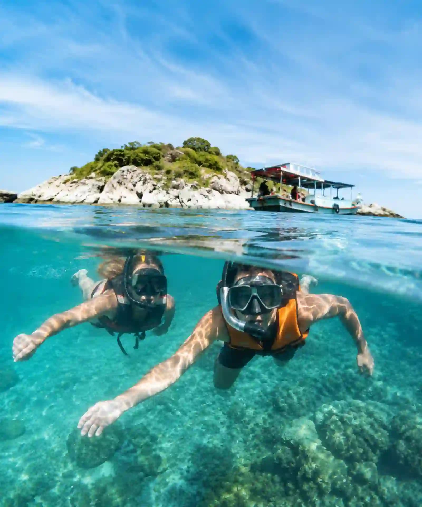 Koh Samet Sun, Sand, and Samet: What You Need to Know Before You Go 8 Two travellers snorkelling responsibly near a small rocky island off Koh Samet