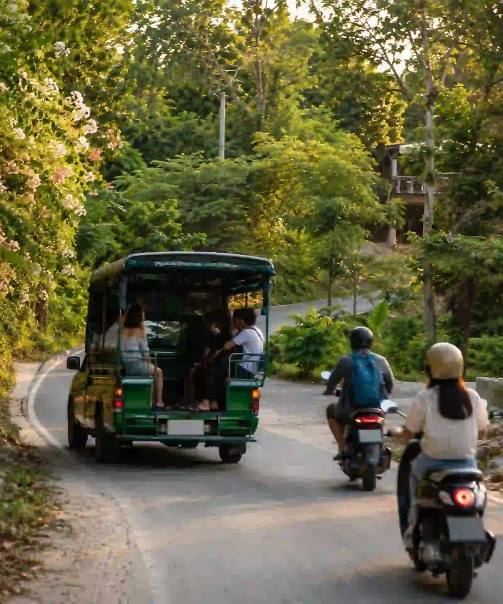 Koh Samet Sun, Sand, and Samet: What You Need to Know Before You Go 9 A green songthaew and helmeted scooter riders travelling along Koh Samet’s main road
